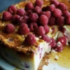 baked raspberry cheesecake on a serving platter