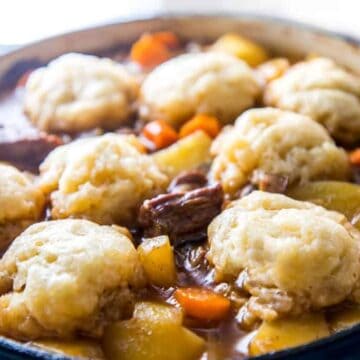 close up of a cooked casserole with dumplings on top
