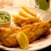 fish chips and mushy peas on a plate