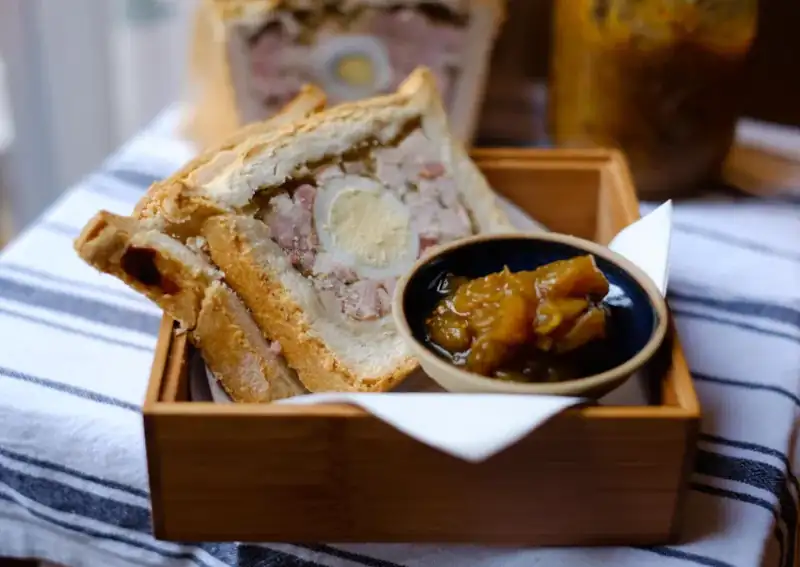 two slices of gala pie with chutney